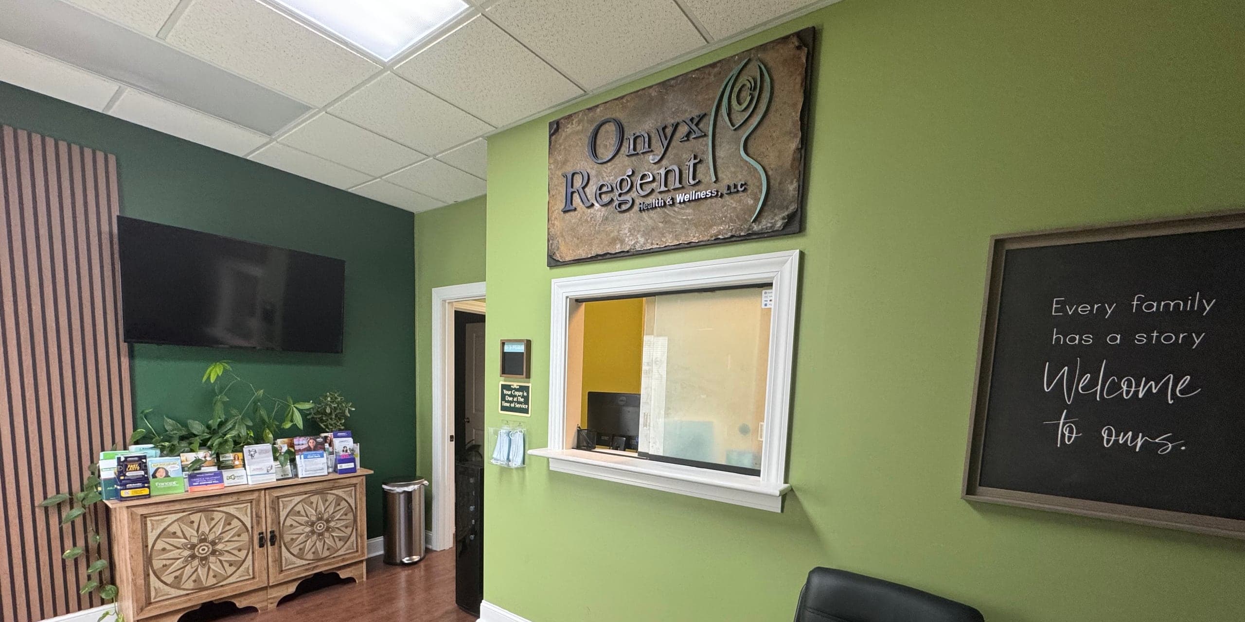 The Onyx Regent Health & Wellness waiting room, with the Onyx Regent sign above the reception window